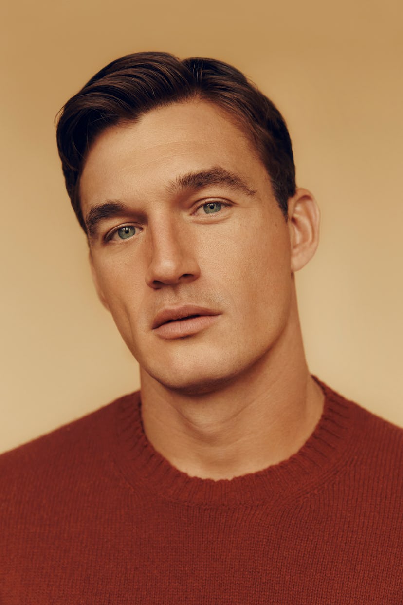 Closeup of Tyler Cameron in a red sweater