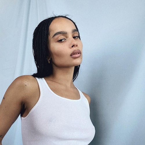 Zoë Kravitz poses in a white tank top.