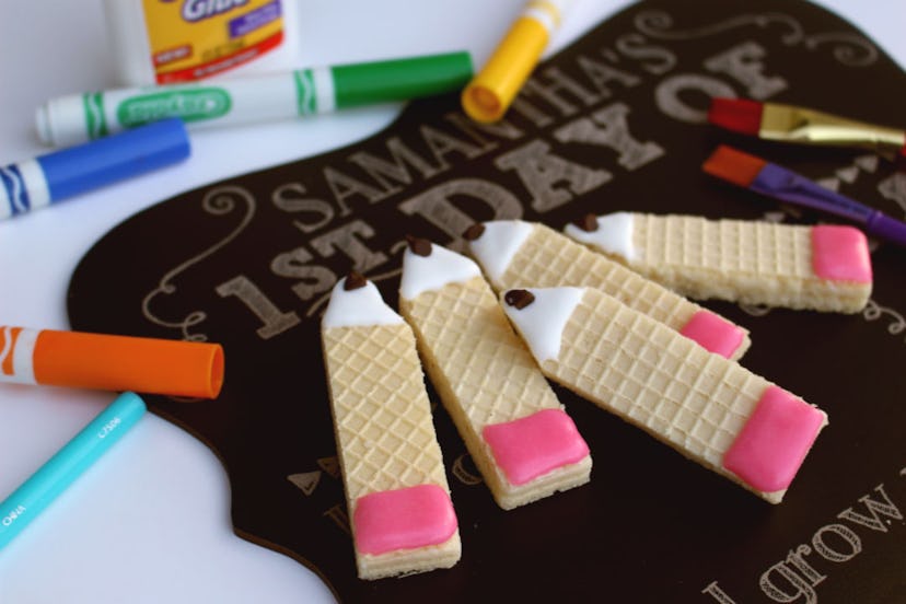 rectangular wafer cookies decorated with icing to look like pencils with pink erasers
