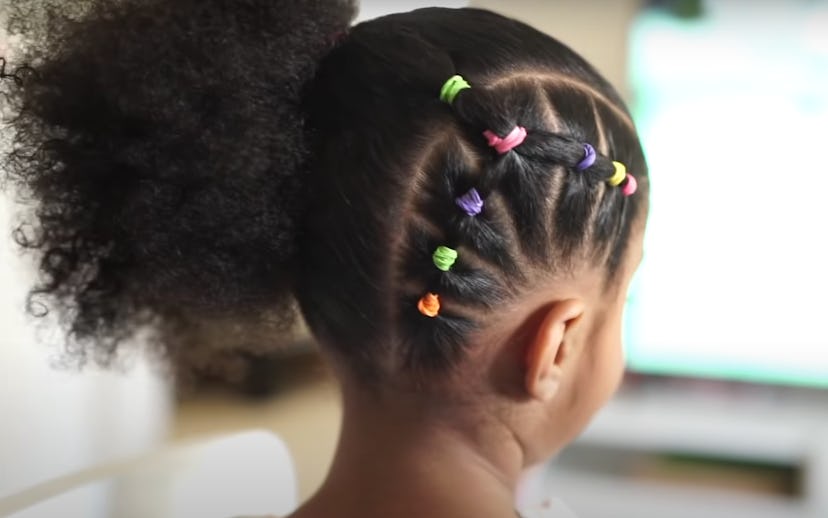 Young girl with natural hair styled with colorful bands