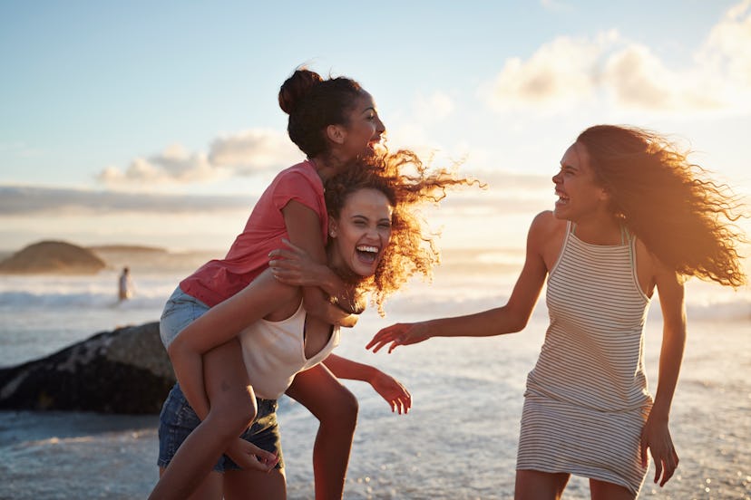 3 young women laughing at the beach, in need of caption for trip with friends, travel with friends c...