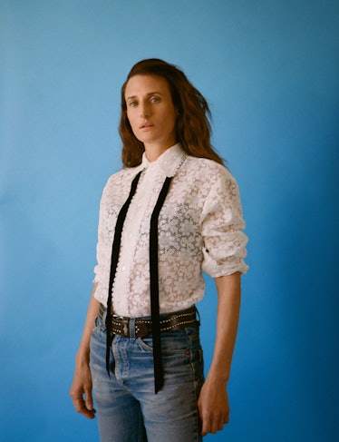 camille cottin stands in front of a blue backdrop