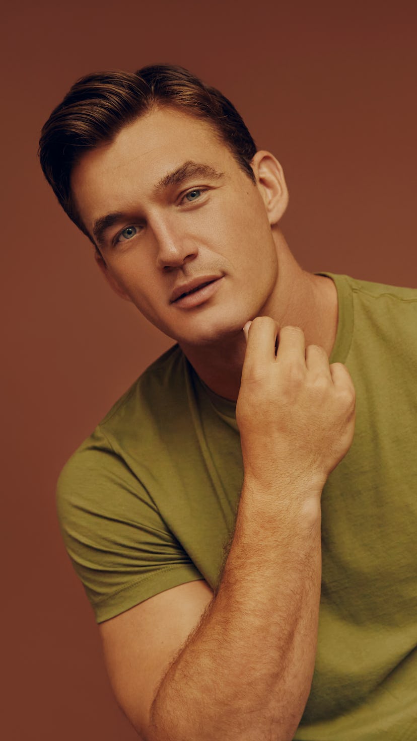 Tyler Cameron posing in a green t-shirt