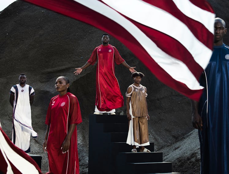 Models wearing Telfar’s Liberian Olympic Team uniforms in red, gold, and navy