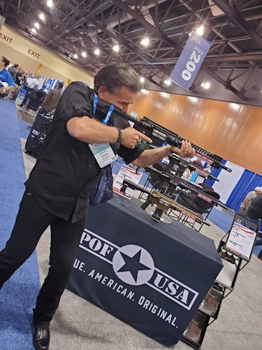 Private eye Jake Schmidt tries an AR-15 at the National Sheriffs' Association in Phoenix 2021