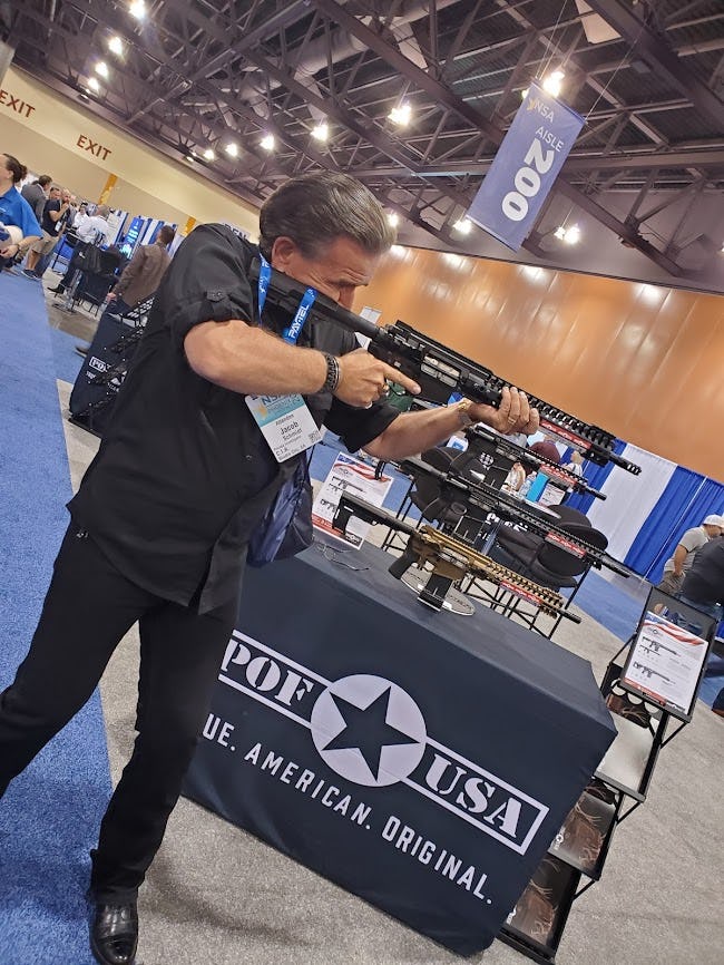 Private eye Jake Schmidt tries an AR-15 at the National Sheriffs' Association in Phoenix 2021