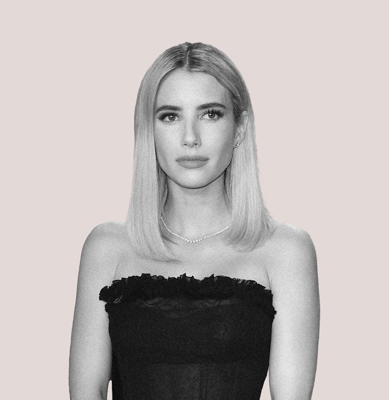 Emma Roberts in black and white wearing a black dress in front of a beige background