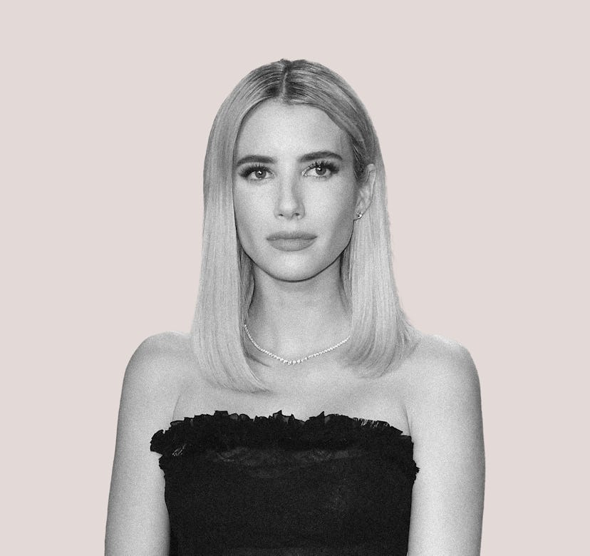 Emma Roberts in black and white wearing a black dress in front of a beige background