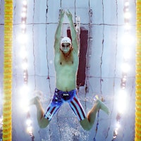 Michael Andrew of Team United States competes in heat five of the Men's 100m Breaststroke on day one...