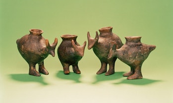 Photo shows four ceramic vessels each with an opening on top and shaped in the form of an animal wit...