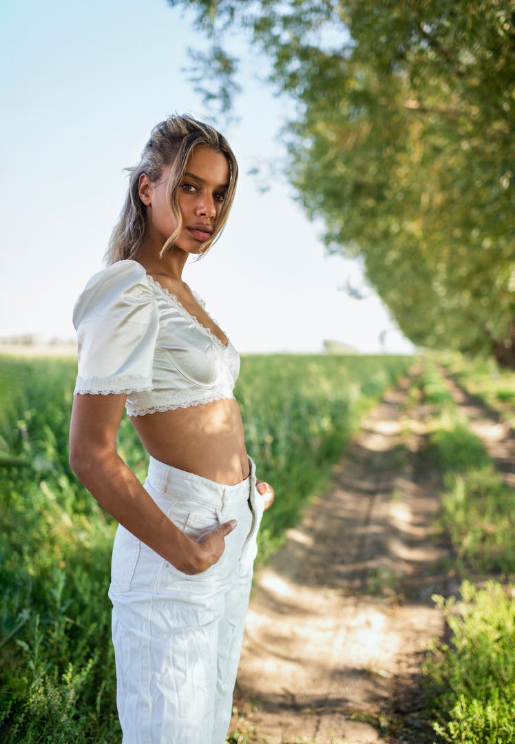 Young woman standing outdoors during the August 2021 new moon in Leo, which affects her the least.