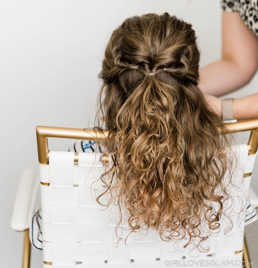 Back of a child's head; curly hair in a half-up style with twists