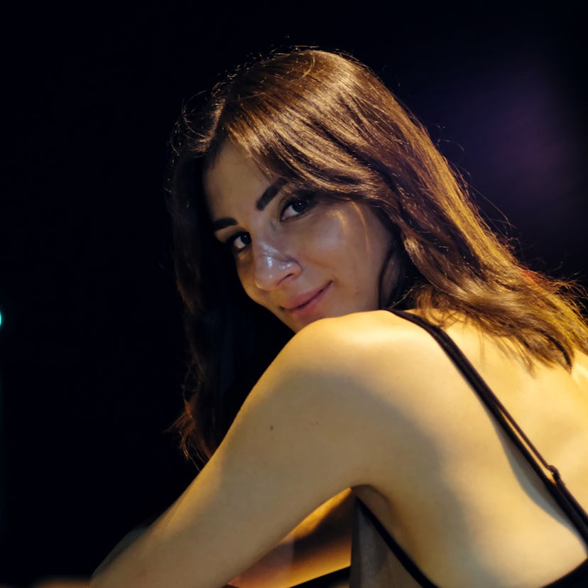 Young woman looking over her shoulder to show the spiritual meaning of the new moon in Leo.