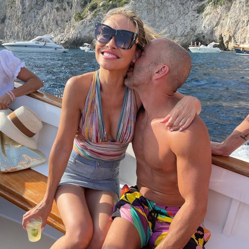 Jason nuzzling Chrishell's neck on a boat.