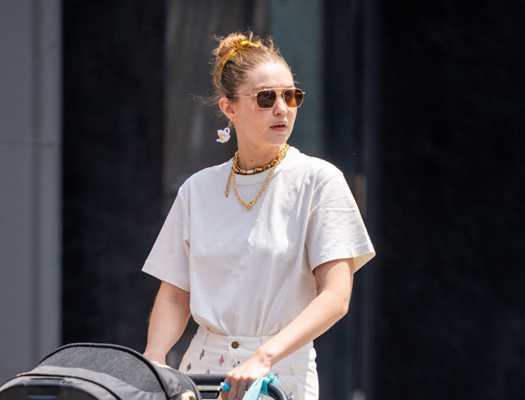 Gigi Hadid wearing a single teapot-shaped earring