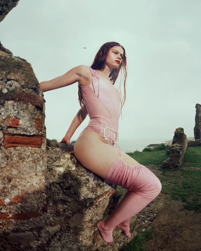 A model wearing a pink corset and knee-high socks by Dilara Findikoglu