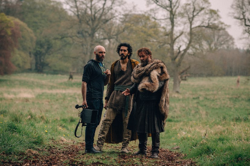 David Lowery, Dev Patel, and Joel Edgerton on set of The Green Knight. Courtesy of A24.