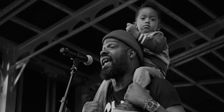 Shawn William performs with his son. 