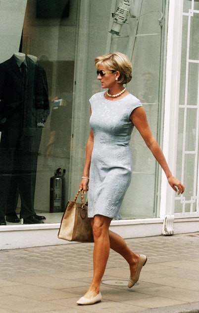 Princess Diana in a white dress, Christian Dior sunglasses and a bamboo  handle taupe coloured Gucci bag.
