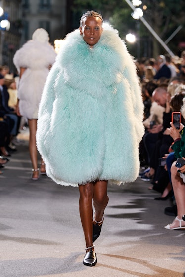 A model walking the runway in a light blue fur coat by Alaïa 