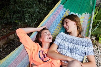 Sisters laying in a hammock to show comments you can post on your little sister's pic.