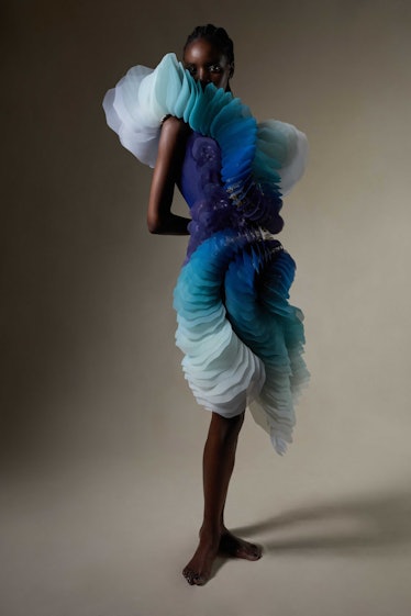 A model in a tulle Iris Van Herpen gown with ruffles all down the front and sides 