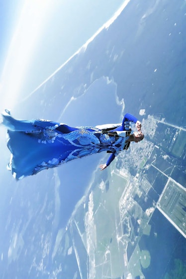 A model skydiving in a blue Iris Van Herpen gown 