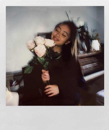 Sarah Griffiths, 20-year-old singer, known as Griff, in a polaroid holding a bouquet of white roses ...