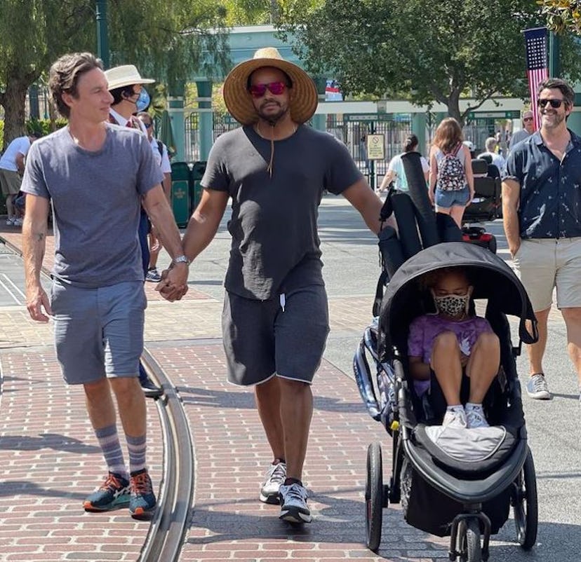 Zach Braff and Donald Faison holding hands at Disneyland together on June 15 , with Braff's daughter...
