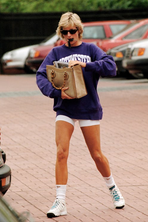 Princess Diana holds her bamboo-handled Gucci bag in her arms. She's on her way to or from the gym w...