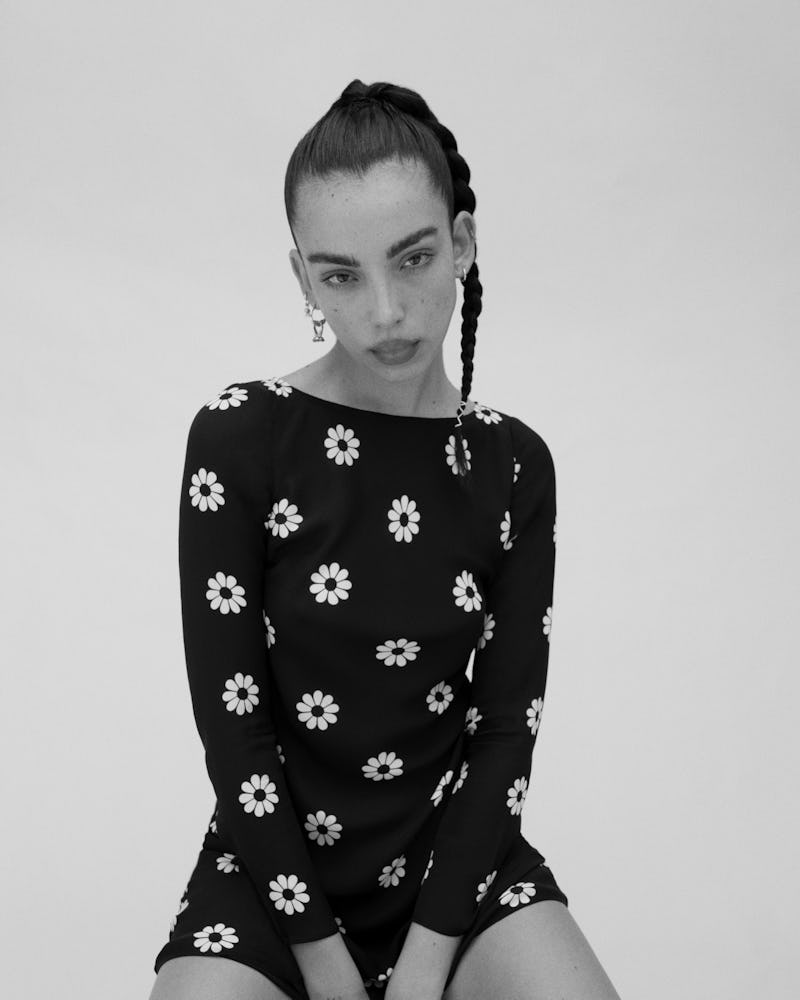 Model wears the black-and white, daisy-printed Cosima dress from Réalization Par x Claudia Schiffer ...