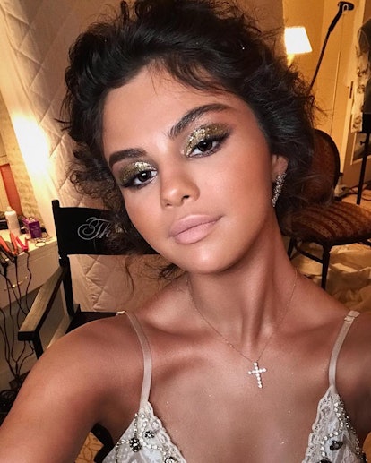 In line with the Met Gala’s 2018 theme, Heavenly Bodies: Fashion and the Catholic Imagination, Selena Gomez went for an angelic effect, donning gold, glittery lids, an all-over tan, and nude lips. 