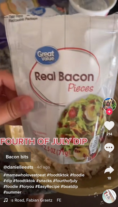 A woman holds up bacon bits to put in her boat dip recipe from TikTok.