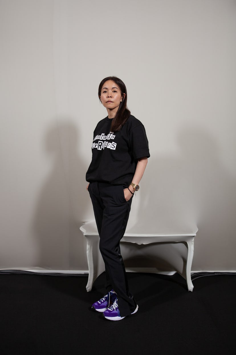 The Sacai's designer Chitose Abe posing in an all-black outfit