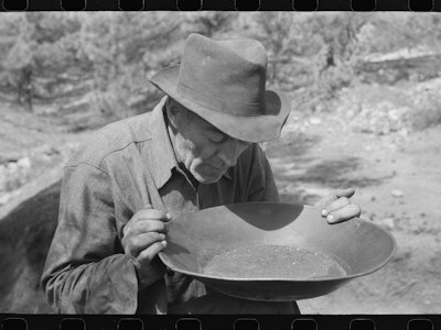 a prospector with a pan of gold