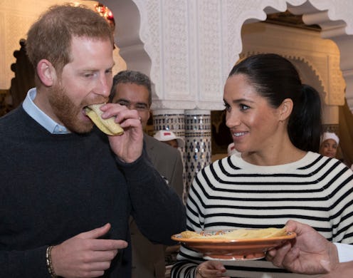 Prince Harry and Meghan Duchess of Sussex, try pancakes at a cooking school demonstration in Rabat.