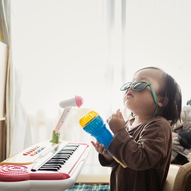 baby rocking out in sunglasses with toy microphone and keyboard, top j baby names