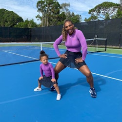 Serena Williams and her daughter Olympia wear matching tennis outfits.