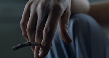 Ripley's hand with dangling cigarette