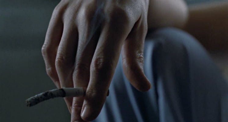 Ripley's hand holds a dangling cigarette in Aliens.