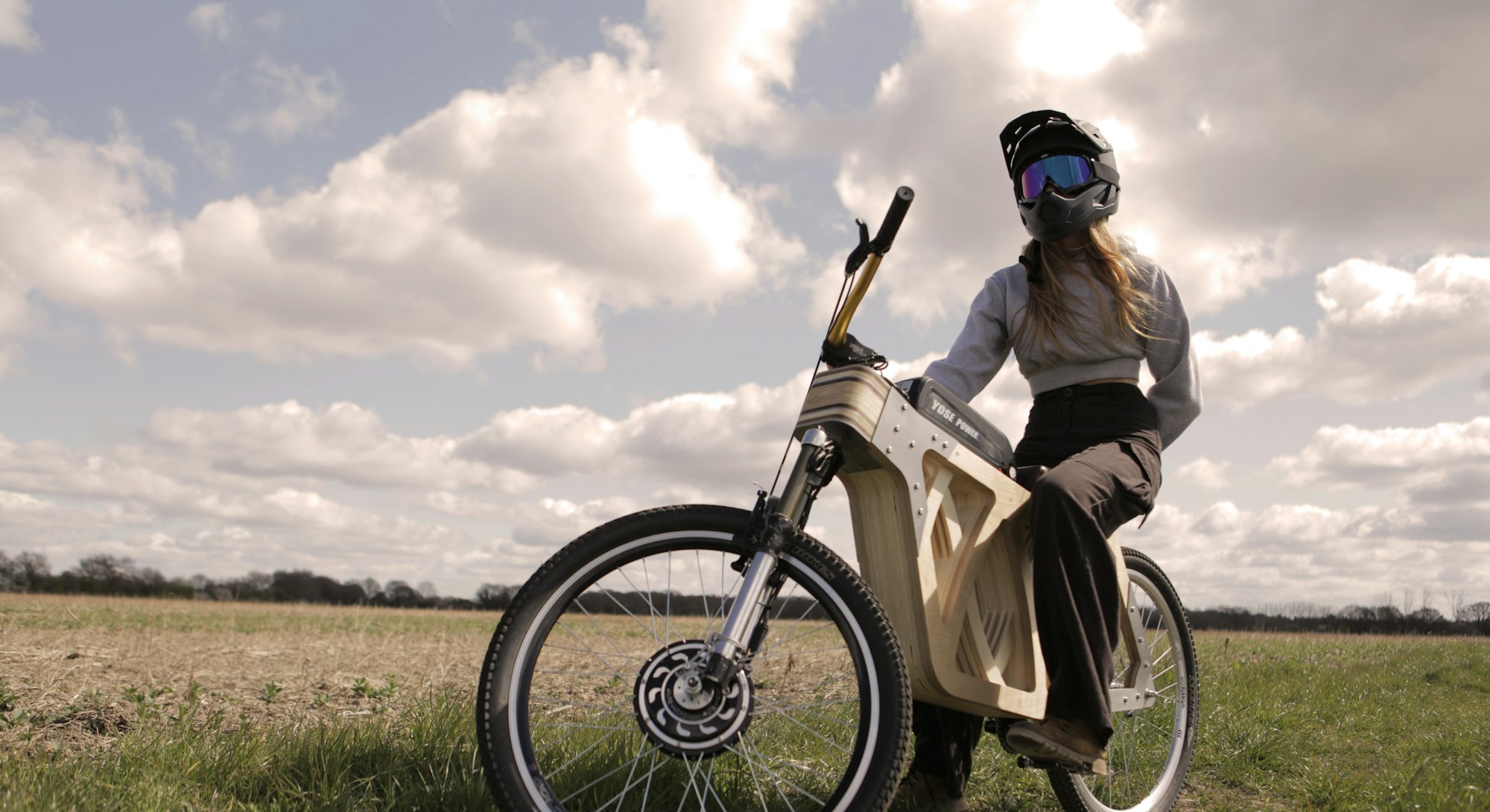 A high-res image of Electraply, a wooden electric bike made by mode maker, Evie Bee. Electric vehicl...