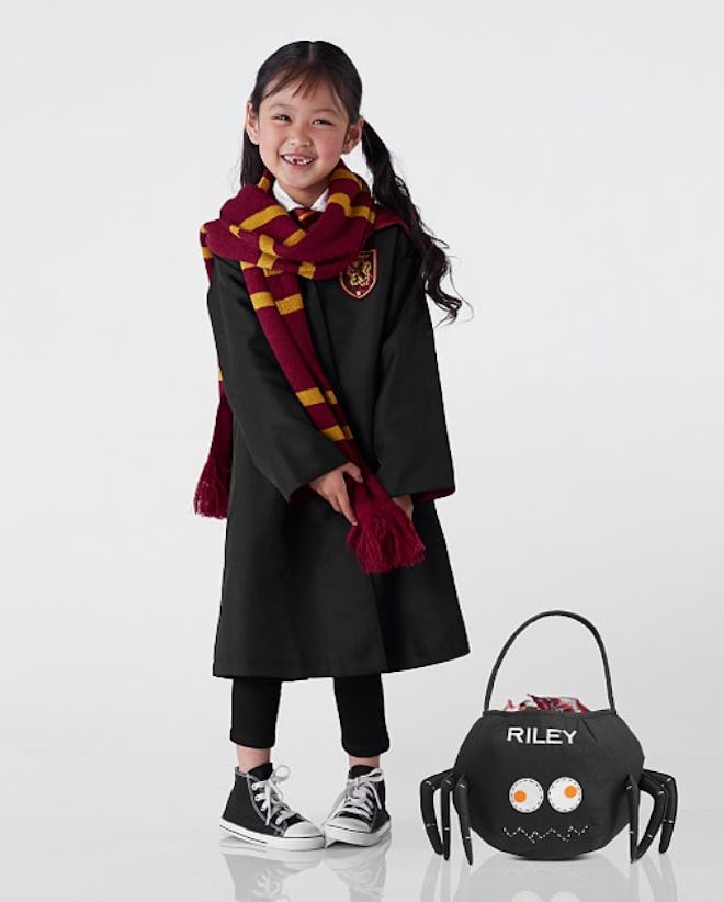 Little girl wearing Harry Potter costume for Halloween