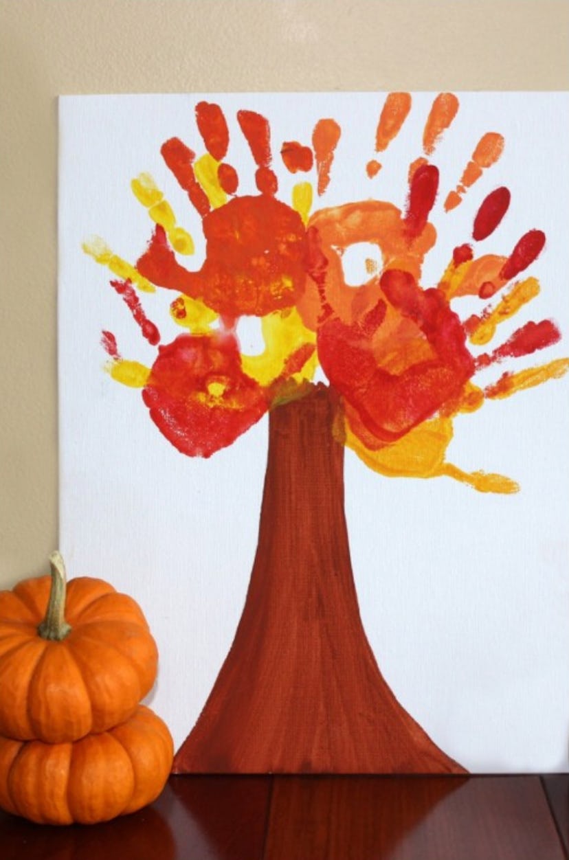 A fall-themed tree is one Halloween handprint art idea.