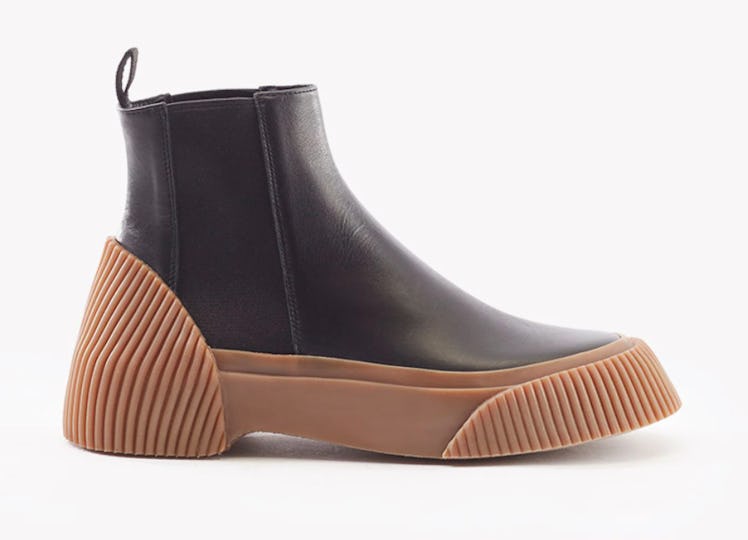 Phillip Lim's Lela Chelsea Boots in black with brown soles. 