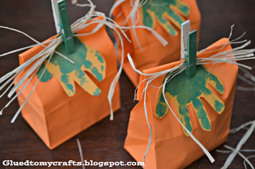 Handprint pumpkin bags is a Halloween handprint art idea to make.