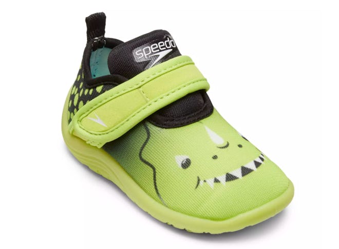 A speedo water sock shoe with a dinosaur face on it