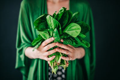 woman holding edible plants