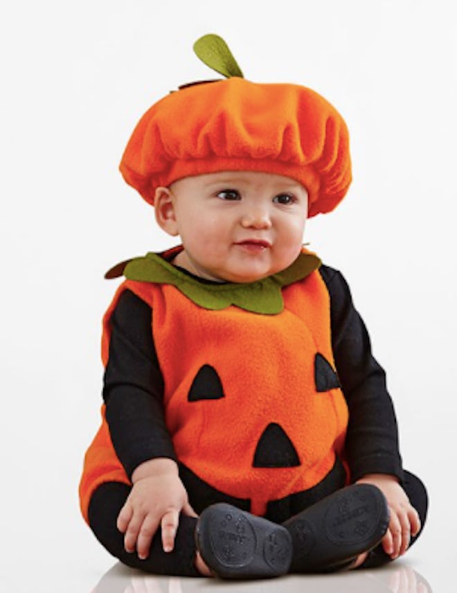 Baby wearing a pumpkin Halloween costume