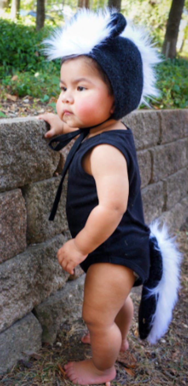 Baby in a skunk costume