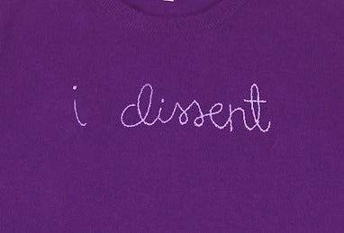purple sweater with "i dissent" stitching